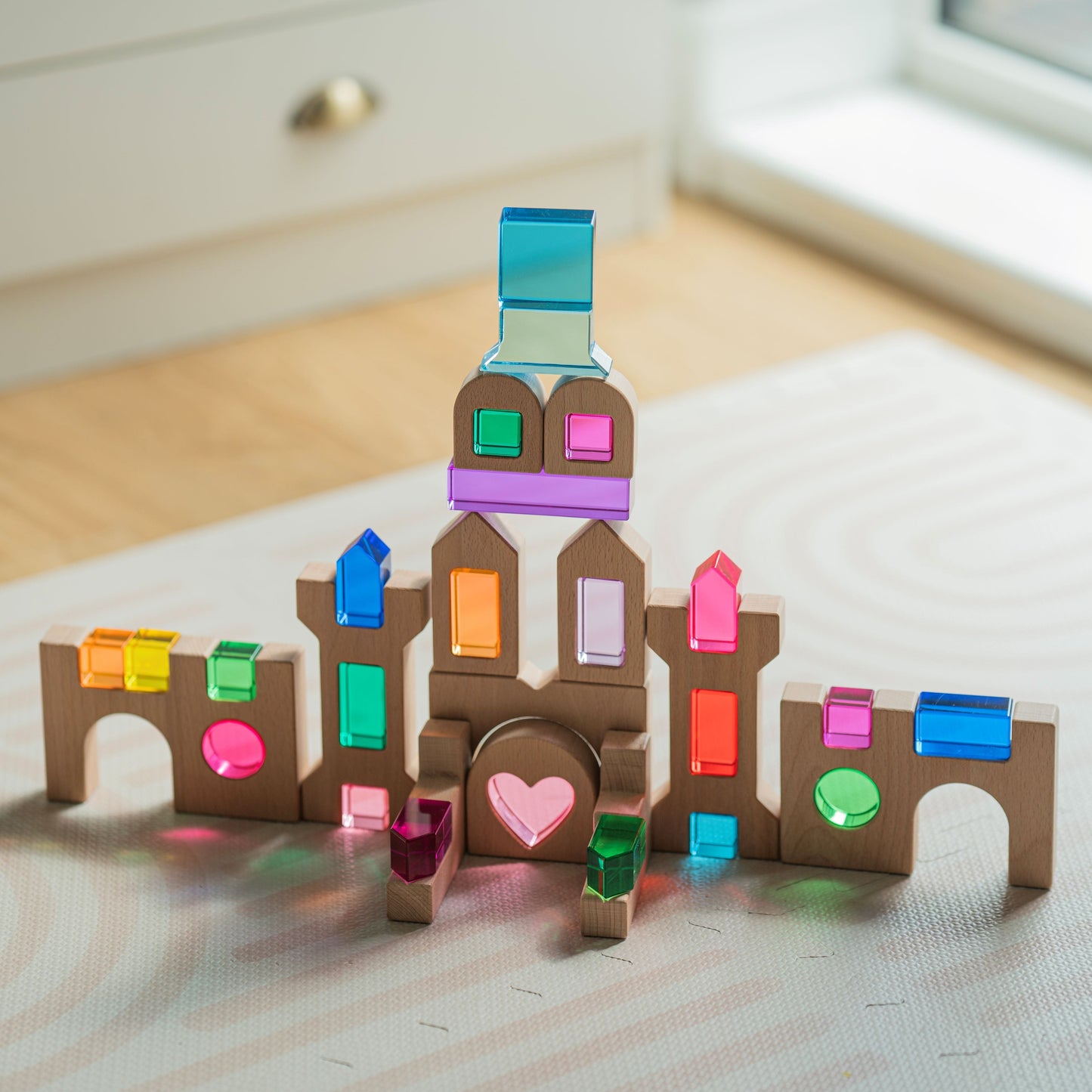Heart of the Lucite Kingdom set with lucite hearts, rounds and cubes beside beechwood castle blocks