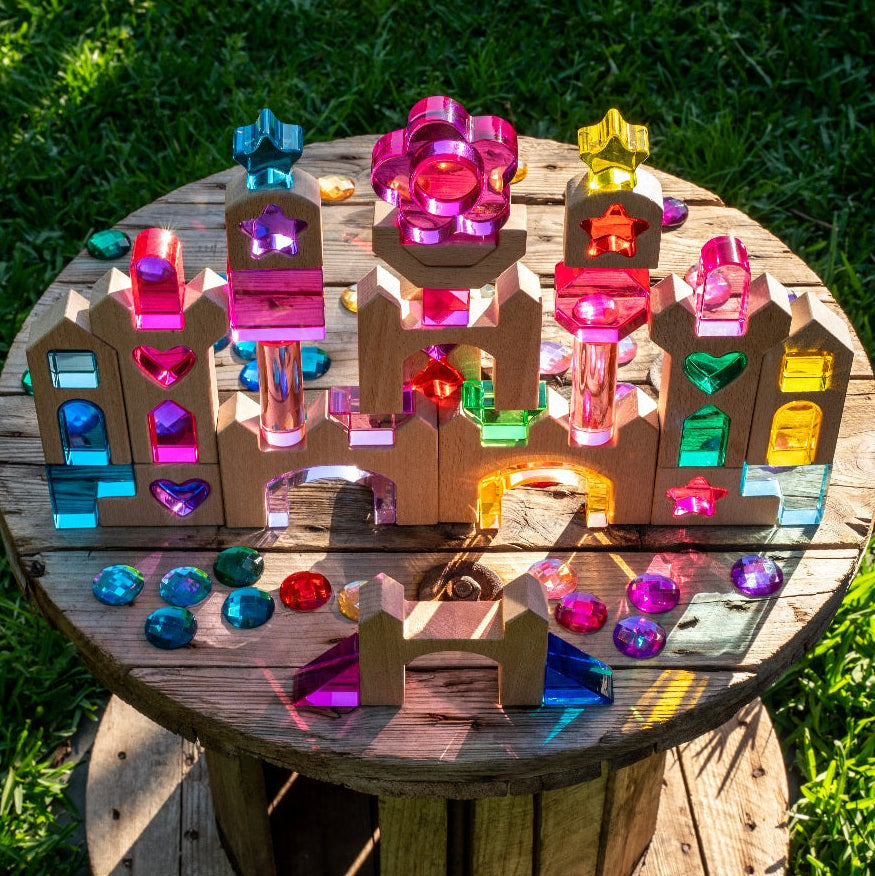 Star of the Lucite Kingdom set with lucite hearts, stars, houses and arches beside wooden castle blocks as a sparkling castle