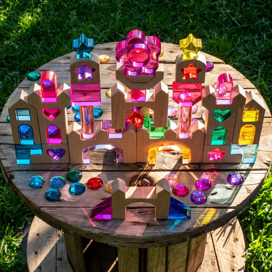 Star of the Lucite Kingdom set with lucite hearts, stars, houses and arches beside wooden castle blocks as a sparkling castle